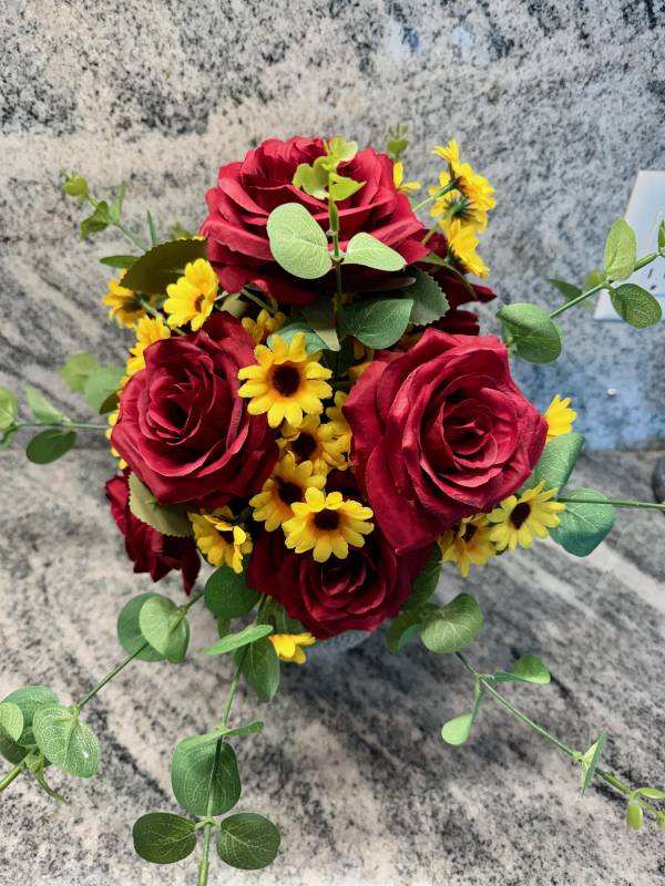 life style shot of red rose and yellow daisies