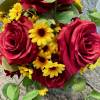up close red rose, yellow daisy, and eucalyptus