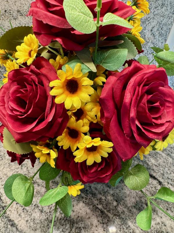 up close red rose, yellow daisy, and eucalyptus