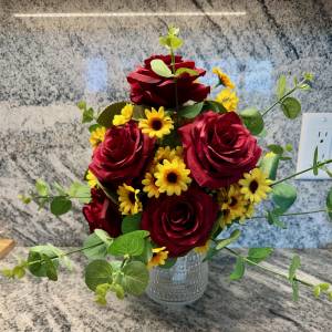life style shot of red rose and yellow daisies